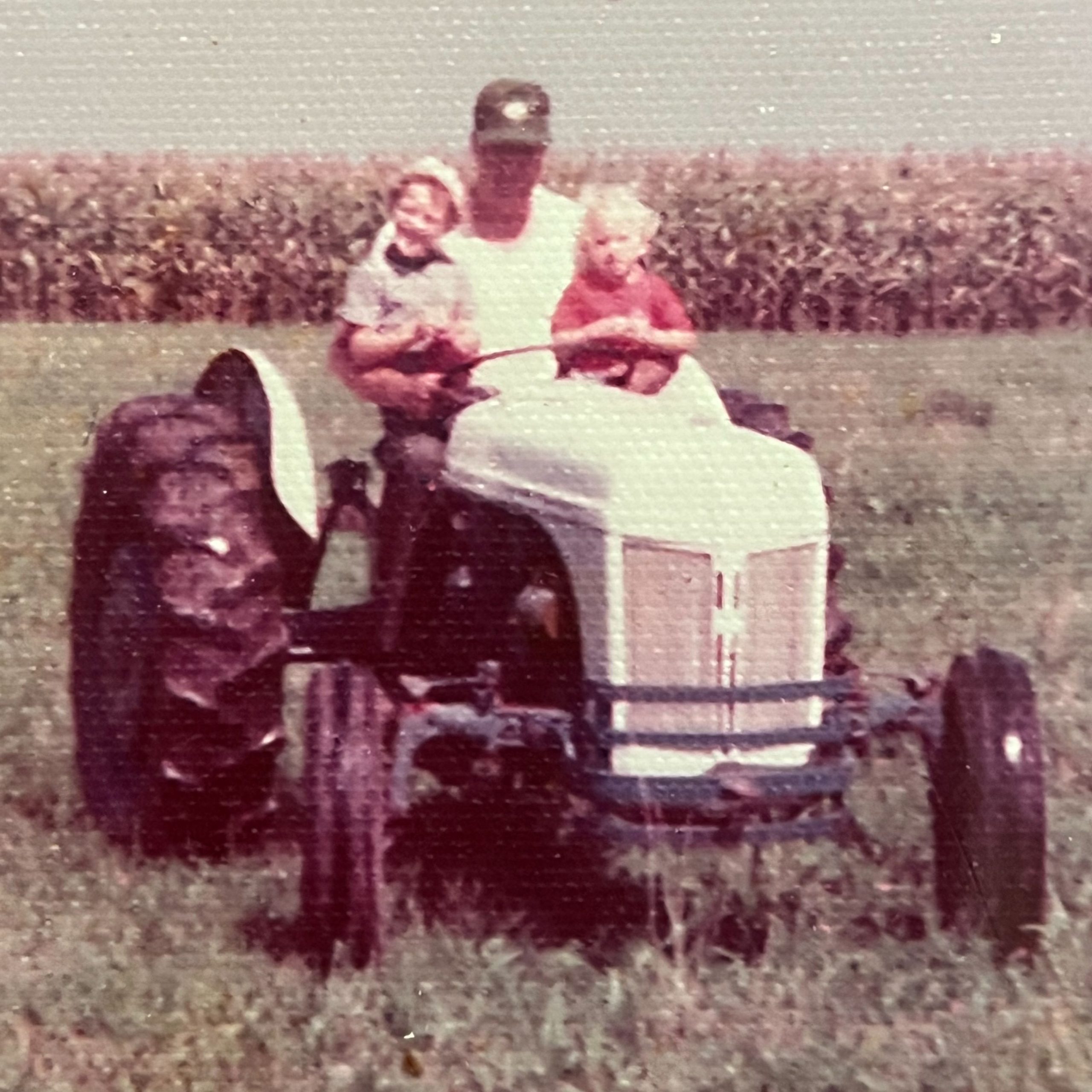Treasurer Frerichs' grandpa on a tractor with two boys