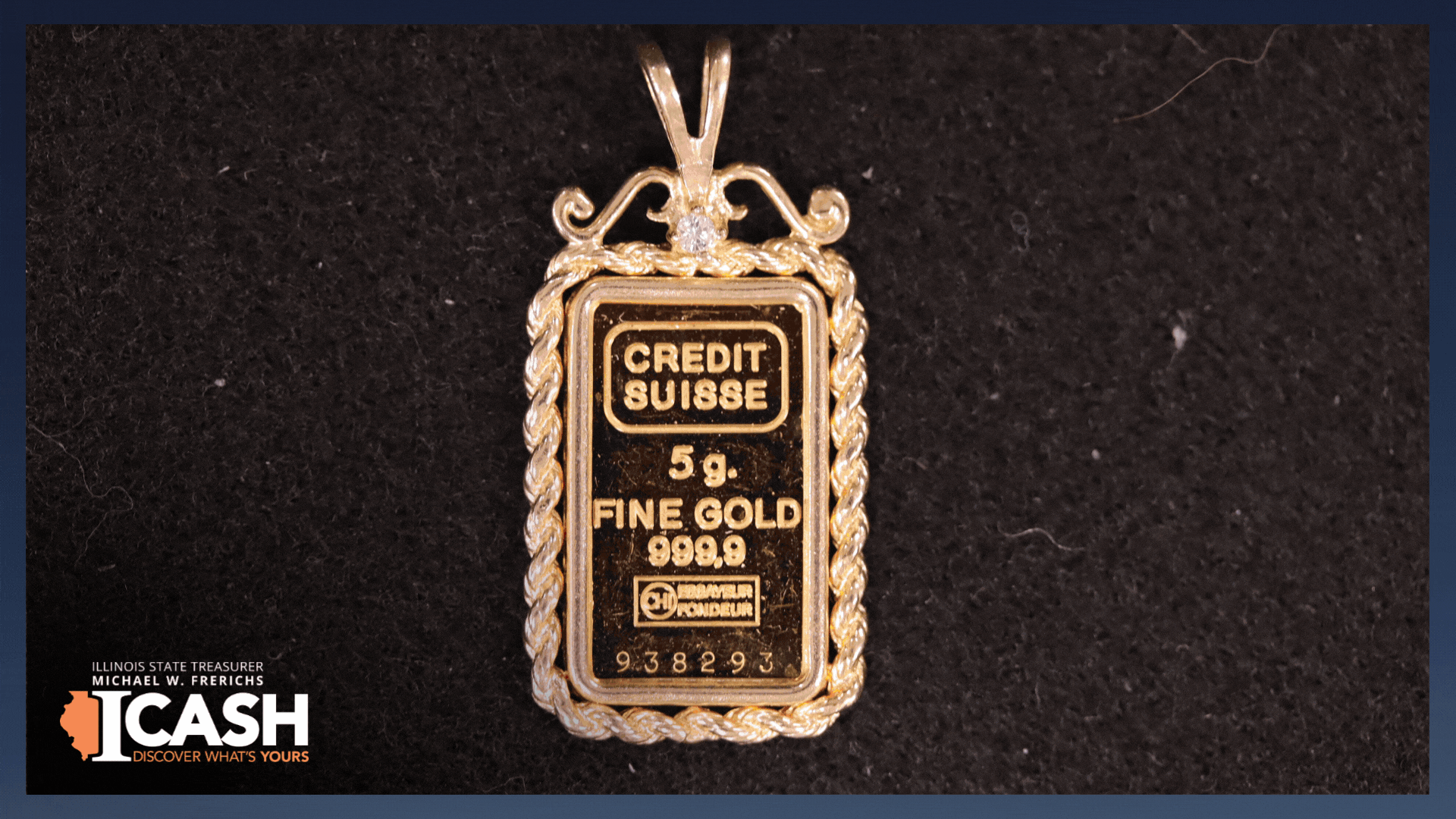gif: a gold pendant on a chain on a black surface