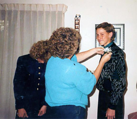 Illinois Treasurer Michael Frerichs as a teen getting his corsage adjusted by two women