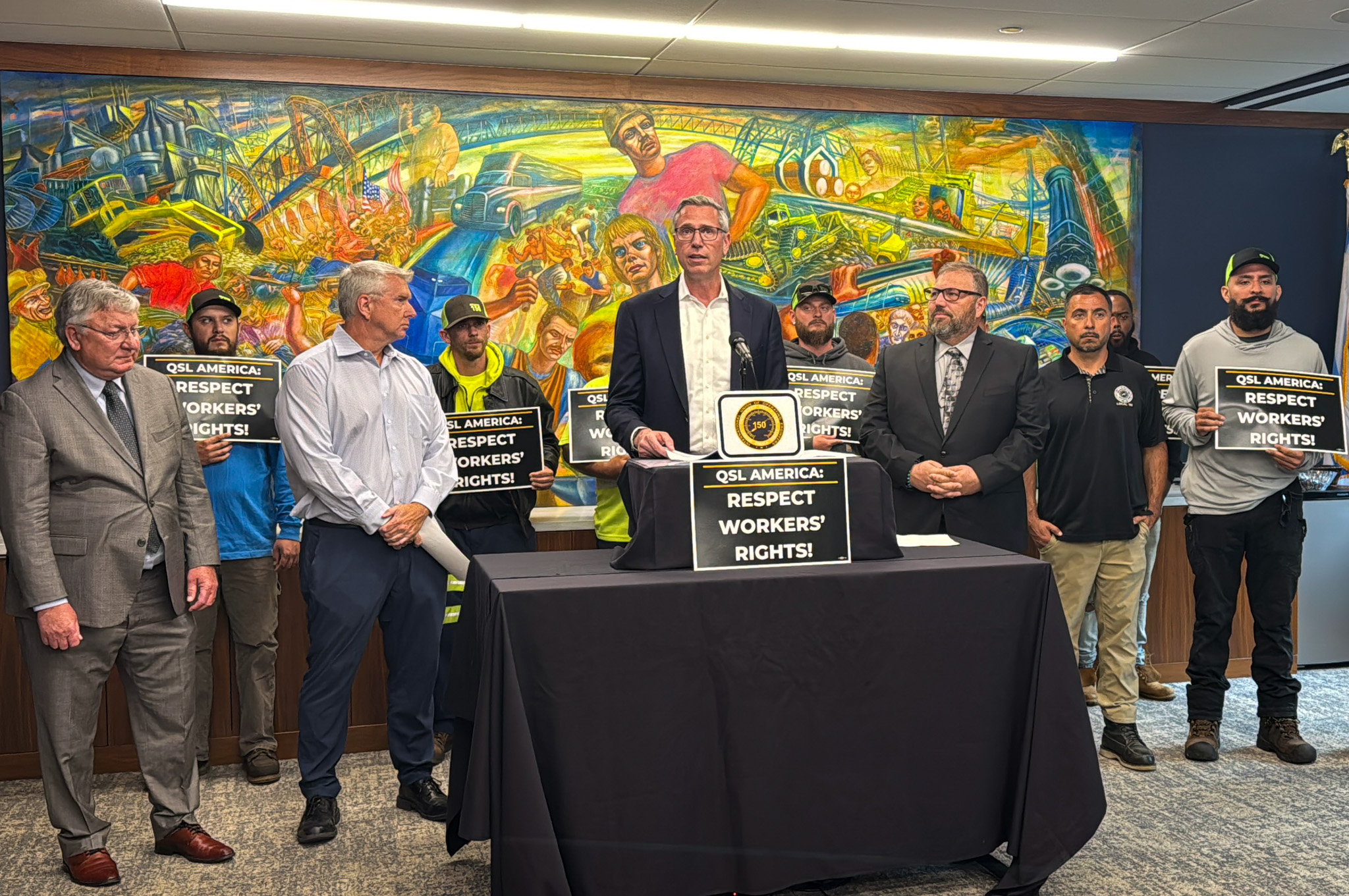 Treasurer Frerichs with a group of men holding signs that say Respect Workers Rights