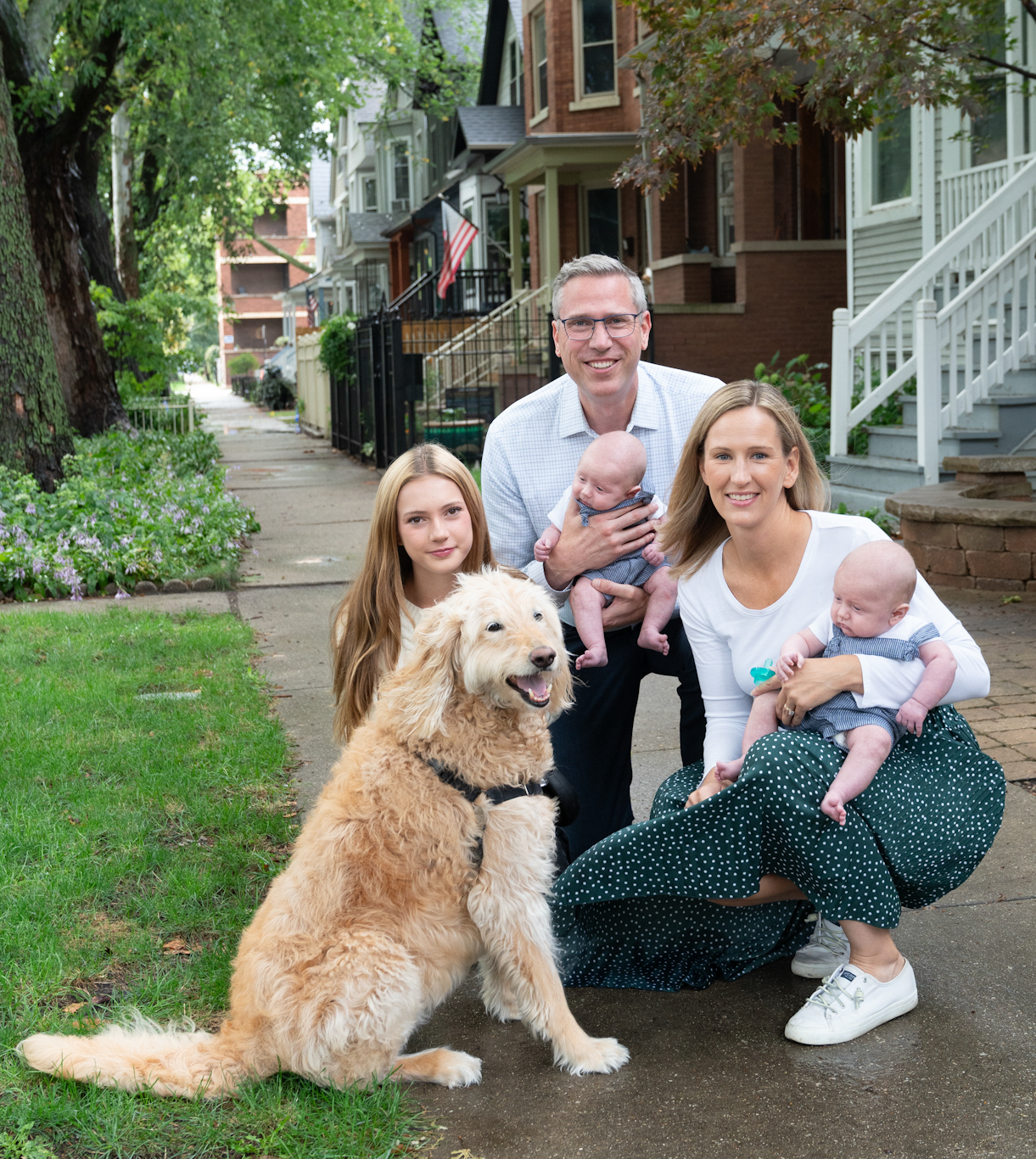Treasurer Frerichs with his wife, children and dog Mila pose for a picture on the sidewalk
